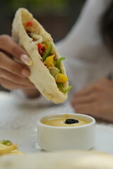 close up of hand holding a food 