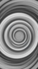 Abstract gray swirl pattern features concentric circles with blurred edges creating an indistinct vortex shape