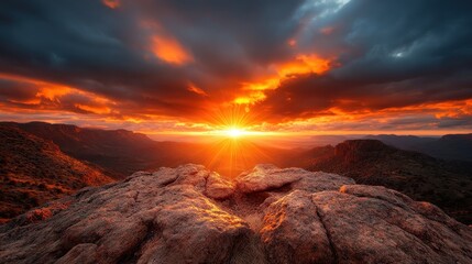 Fototapeta premium A stunning sunset illuminates a rugged rocky landscape, casting shadows and highlights across the terrain as the sun dips below the horizon, creating a breathtaking visual spectacle.