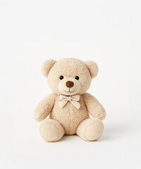 Cute beige plush teddy bear with a bow tie sitting upright on a white background. Soft toy for children, perfect for baby gifts or nursery decor.

