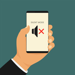 Smartphone in silent mode held by man. Hand holds a smartphone displaying a muted speaker icon with the words Silent Mode