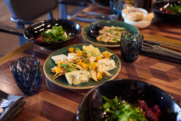 A gourmet dish with bread and fresh, flavorful ingredients elegantly arranged on a plate