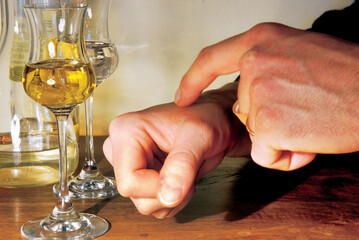 Man checking his pulse after drinking alcohol, pulse taking, alcohol abuse