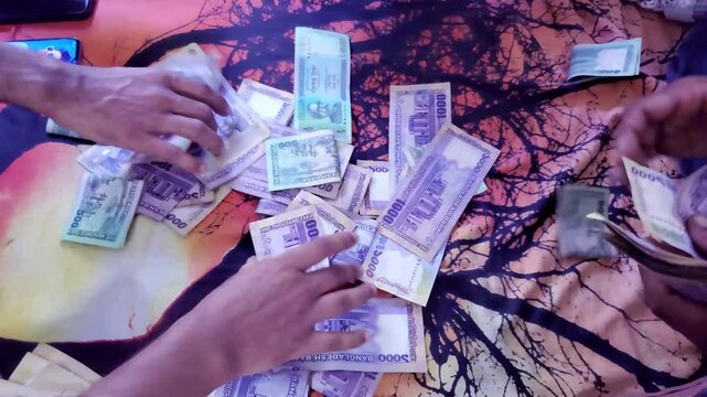 Bangladesh Currency Banknotes. People touching money with hands. man counting Bangladesh money and counting Bangladeshi 1000 taka banknotes.