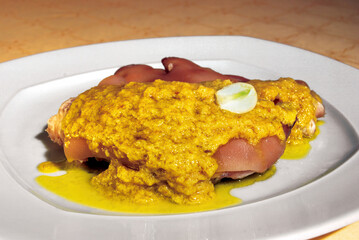 Pig's trotters with mustard sauce and garlic on white plate