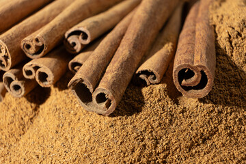 Close-Up of Ground Cinnamon and Brown Sticks.