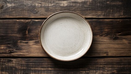 Empty white plate on dark wooden planks