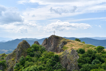 Mountain ridge with cross and panoramic forest view