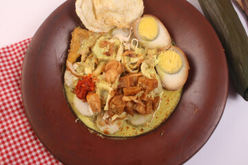 a plate of lontong opor, traditional indonesia cuisine