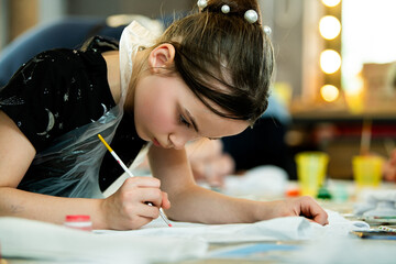 Young Girl Focused on Painting at Art Class