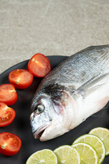 Raw Uncooked Dorado Fish with Fresh Sliced Lime Ready to Cook.
