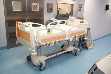 Empty modern hospital bed in a sterile hospital room