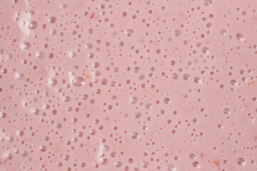 Strawberry milkshake surface, abstract cooking pink background with bubbles.