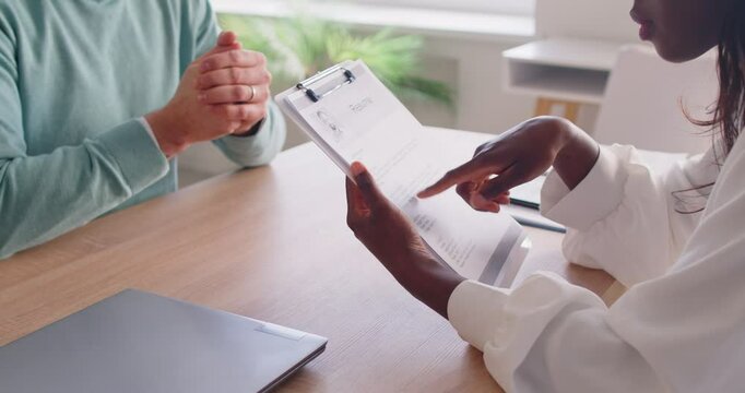 African american consultant, woman reading resume interviewer to ask male candidate, experiences, education and skills, conversation between job applicant and representative of employer, talking 