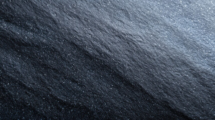 Elegant black stone background with rough, natural texture. dark slate surface has subtle shimmer from mineral flecks, creating dramatic and solid backdrop