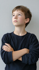 Pensive, thoughtful young boy with serious expression looking up. caucasian child portrait capturing moments of deep contemplation and determined ambition for future