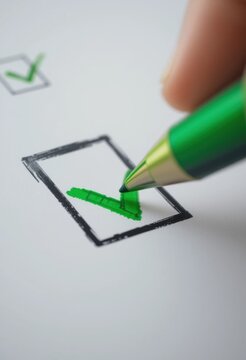 Mano con bol&iacute;grafo marcando una lista de verificaci&oacute;n con una marca de chequeado verde