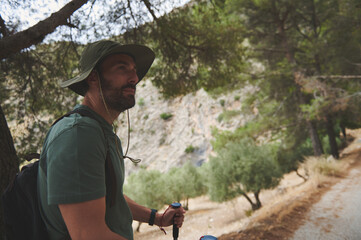 Man Hiking Through Scenic Forest Trail in the Mountains
