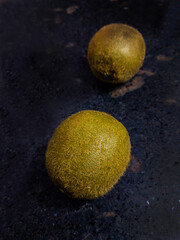 Kiwi fruit shot taken in Kitchen on a black Background, photo is selective focus with shallow depth...