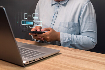 Backup, copy file or exchange data concept. Woman transfer files from mobile phone to laptop.