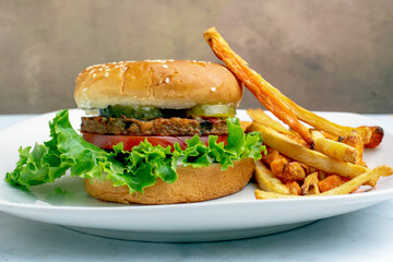 gadenveggie burger top with pickles on a sesame bun