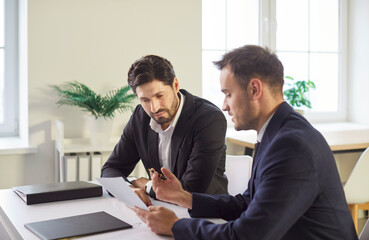 Serious lawyer, solicitor or barrister, supervisor talk to analyse financial report, professional...