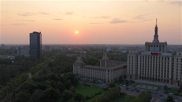Aerial Bucharest. 6k video during a summer sunset in the north part of the city, next to Herastrau Park and Piata Presei Libere (Free Press Square) landmarks. Travel to Bucharest, Romania. Drone film