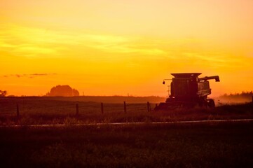 Fototapeta premium Combine Harvester at Sunset