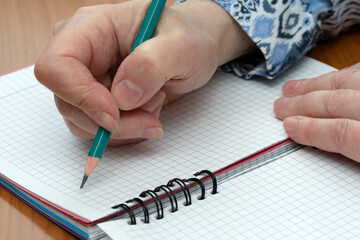 Writing notes in a lined notebook during brainstorming