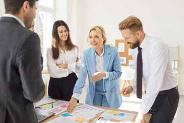 Obraz na płótnie Canvas Professional team of coworkers working together on accounting and business plan development during an office meeting or conference, emphasizing collaboration and strategic planning during paperwork.