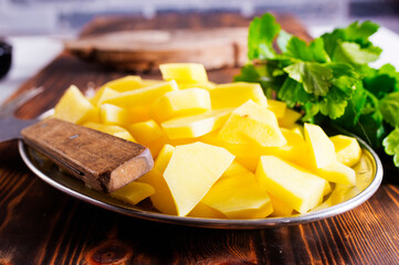 Spiced pieces of raw potato prepared to bake.