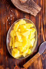 Spiced pieces of raw potato prepared to bake.