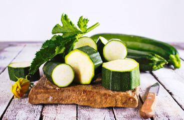 Slicing zucchini on a cutting board. Ripe zucchini. Top view, horizontal.