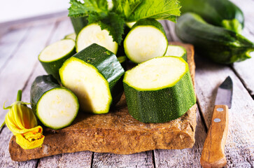Slicing zucchini on a cutting board. Ripe zucchini. Top view, horizontal.