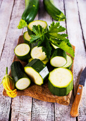 Slicing zucchini on a cutting board. Ripe zucchini. Top view, horizontal.