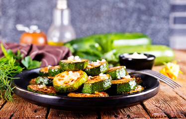 Tasty fried zucchini slices on a plate