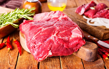 Raw meat on cutting board, with herbs, spices on cooking table top view copy space