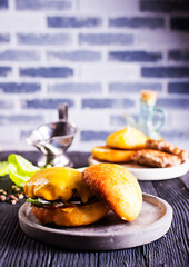Close up cheese burger on wooden background.