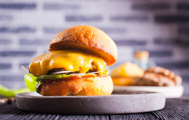 Close up cheese burger on wooden background.