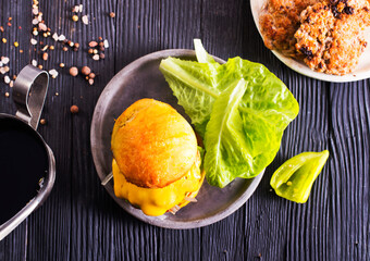 Close up cheese burger on wooden background.