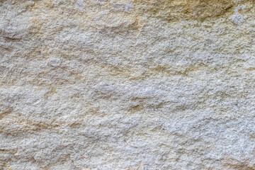 Natural stone texture with rough surface and uneven shades ideal for use as a background or design...