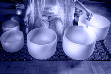 Woman in Sound healing therapy and yoga meditation, uses aspects of music to improve health and...