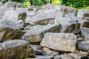 Natural accumulation large unprocessed stones rocks various shapes creating natural stone...