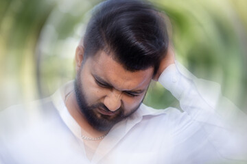 Tired and dizzy South Asian, Indian man having vertigo or dizziness symptoms