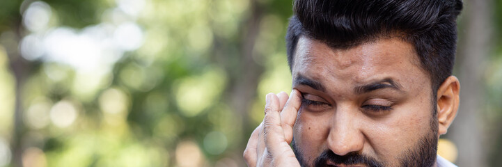 South asian man having vision problem, eye irritation, red eye, dry eye or eye inflammation, optical or eye health care concept