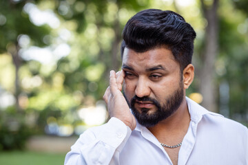 South asian man having vision problem, eye irritation, red eye, dry eye or eye inflammation, optical or eye health care concept