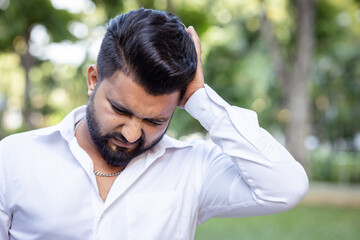 South Asian, Indian man having one-side migraine headache