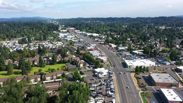 4K drone video showing multiple car dealership buildings, exteriors, with large parking busy lots along SE McLoughlin Blvd in Gladstone, Oregon, USA