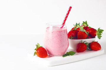 A glass of fresh strawberry smoothie on a white background. Summer drink shake, milkshake and refreshment organic concept.