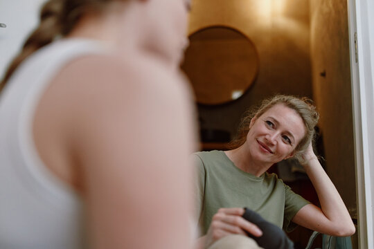 middle age woman enjoying active healthy lifestyle smiling and relaxing indoors promoting wellbeing and fitness for longevity in community